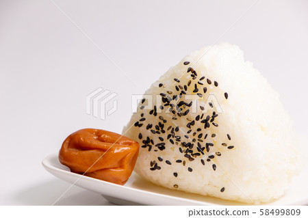 Sesame salt onigiri and plum dried (seasoned plum dried and honey flavored). Sesame salt onigiri and plum dried (seasoned plum dried and honey flavored). 58499809
