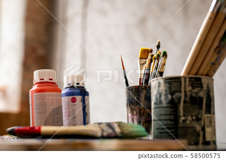 Set of paintbrushes in tin cans and two plastic jars with red and blue gouache Set of paintbrushes in tin cans and two plastic jars with red and blue gouache 58500575