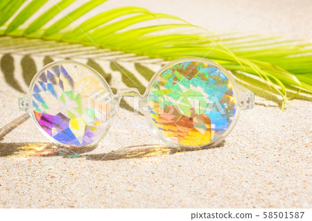 Funny kaleidoscope multicolour glasses on sand Funny kaleidoscope multicolour glasses on sand 58501587