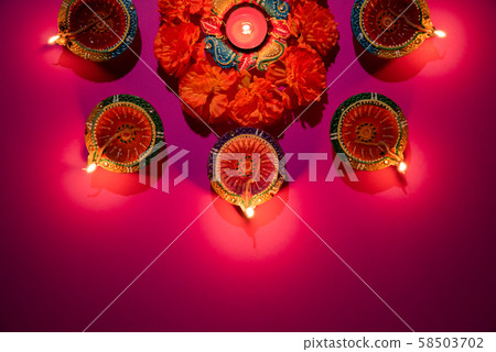 Happy Diwali - Clay Diya lamps lit celebration background 58503702