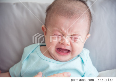 Closeup shot of little asian infant crying Closeup shot of little asian infant crying 58504138