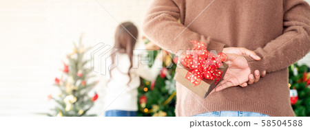 Man hold christmas gift surprise Man hold christmas gift surprise 58504588
