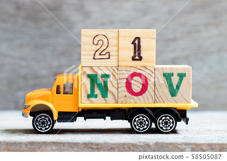 Truck hold letter block in word 21nov on wood background  58505087