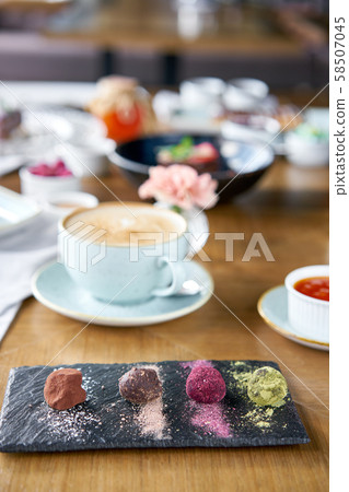 Candy chocolate truffle. Breakfast in the cafe, morning coffee. Cappuccino and lots of desserts on Candy chocolate truffle. Breakfast in the cafe, morning coffee. Cappuccino and lots of desserts on 58507045