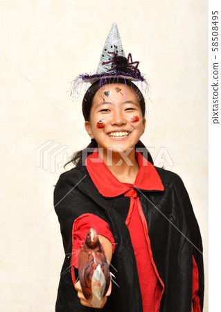 A girl who enjoys a Halloween party 58508495