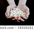 Female hand holding a large amount of medicine 58509281
