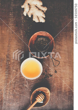 Tea composition on rustic background: tea, mint, lemon, ginger. Tea composition on rustic background: tea, mint, lemon, ginger. 58509750