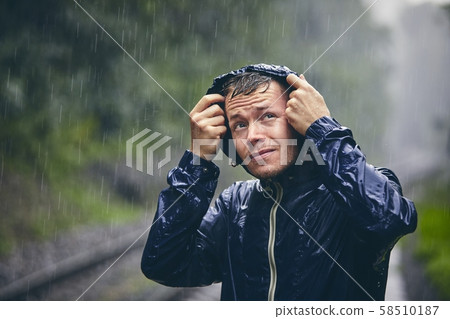 Traveler in heavy rain Traveler in heavy rain 58510187