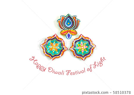 Happy Diwali - Clay Diya lamps lit during Dipavali, Hindu festival of lights celebration. Colorful traditional oil lamp diya on white background. Copy space for text. 58510378