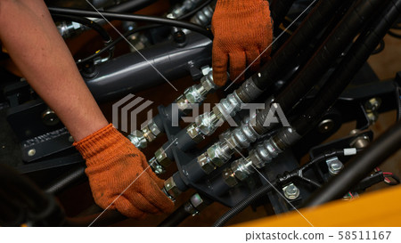Low key photo of hydraulic pipes maintenance on 58511167