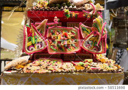 Traditional offerings to gods in Indonesia with flowers, fruits and aromatic sticks in temple Traditional offerings to gods in Indonesia with flowers, fruits and aromatic sticks in temple 58511698