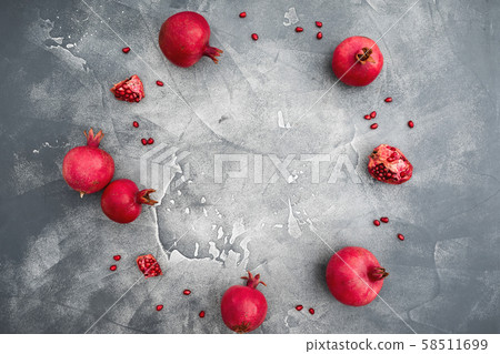 Pomegranate with seeds on dark background. Food background. Flat lay, top view Pomegranate with seeds on dark background. Food background. Flat lay, top view 58511699