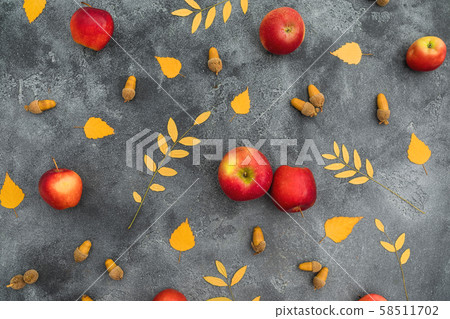 Autumn composition. Fall leaves, apple and acorns on dark background. Thanksgiving day concept Autumn composition. Fall leaves, apple and acorns on dark background. Thanksgiving day concept 58511702