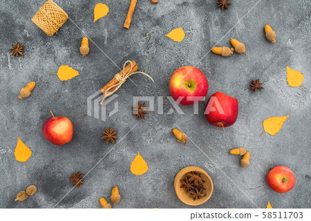 Autumn composition. Fall leaves, apple, cinnamon and acorns on dark background. Thanksgiving day. Autumn composition. Fall leaves, apple, cinnamon and acorns on dark background. Thanksgiving day. 58511703