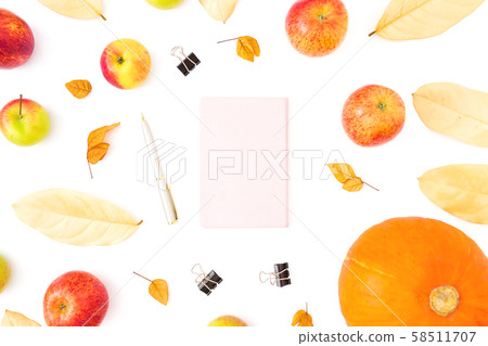 Autumn composition of fall leaves, apple and pumpkin with notebook, pen and clips on white. Autumn composition of fall leaves, apple and pumpkin with notebook, pen and clips on white. 58511707