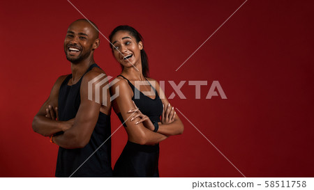 Staying healthy. Young and positive african fitness couple in sportswear looking at camera with Staying healthy. Young and positive african fitness couple in sportswear looking at camera with 58511758