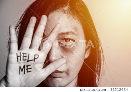 stop violence against women campaign. Asia woman with bruise on arms and face raised her hand for dissuade, hand write the word help me. 58512684
