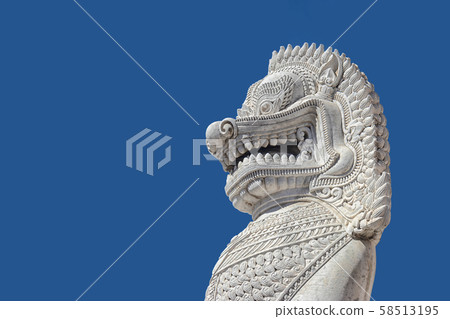 sculpture of ancient white stone singha statue isolated on blue sky background in front of temple in Bangkok, Thailand , Southeast Asia 58513195
