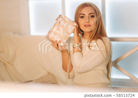 Elegant woman in white dress in winter holiday. Christmas mood Elegant woman in white dress in winter holiday. Christmas mood 58513724