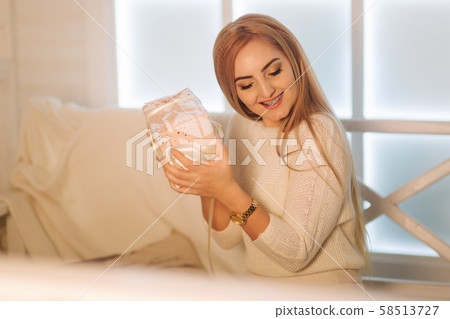 Elegant woman in white dress in winter holiday. Christmas mood Elegant woman in white dress in winter holiday. Christmas mood 58513727