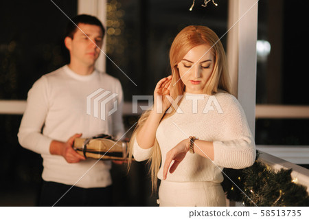Husband gives present for his wife, background of window. Happy woman take present Husband gives present for his wife, background of window. Happy woman take present 58513735