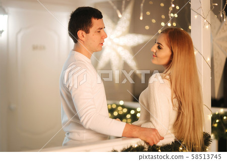 Man and woman in white at Christmas time. Happy family Man and woman in white at Christmas time. Happy family 58513745