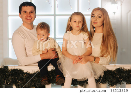 Happy family spend time together on Christmas.Portrait of Mom dad, Daughter and son on winter Happy family spend time together on Christmas.Portrait of Mom dad, Daughter and son on winter 58513819