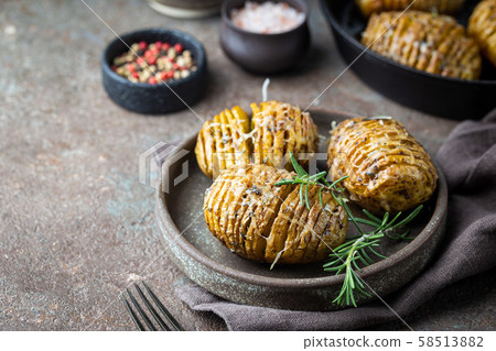 Baked hasselback potatoes Baked hasselback potatoes 58513882