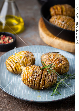 Baked hasselback potatoes Baked hasselback potatoes 58513883