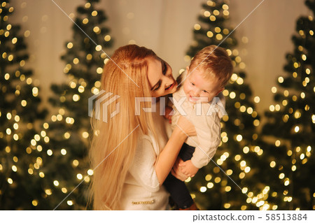 Mom play with her cute little son on holiday. Chrisrmas mood Mom play with her cute little son on holiday. Chrisrmas mood 58513884