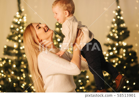 Mom play with her cute little son on holiday. Chrisrmas mood Mom play with her cute little son on holiday. Chrisrmas mood 58513901