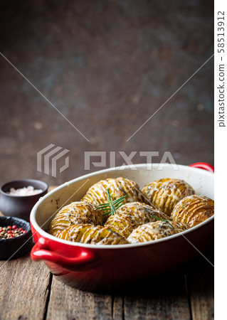 Baked hasselback potatoes Baked hasselback potatoes 58513912