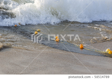 fishing nets rope and floats in sea water 58514789