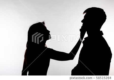 Aggression and abuse concept - man and woman expressing domestic violence in studio silhouette Aggression and abuse concept - man and woman expressing domestic violence in studio silhouette 58515264
