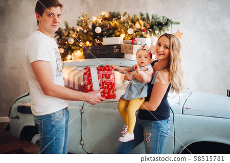 Lovely daddy giving Christmas present, big red box 58515781