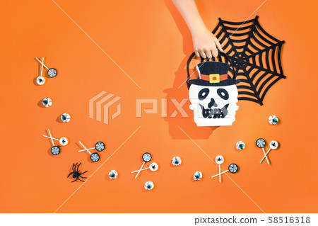 Happy halloween with candies and bucket on orange 58516318