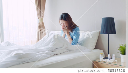 woman sick at home 58517828