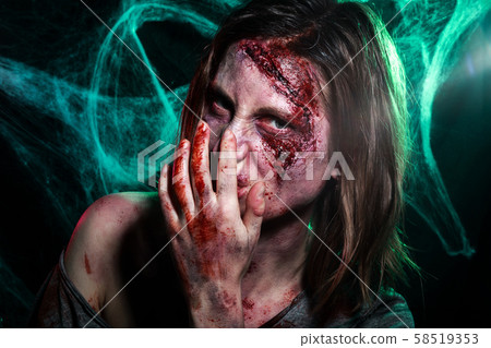 Close-up portrait of horrible zombie woman with wounds. Horror. Halloween make-up and costume 58519353