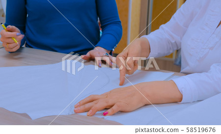 Two tailors working with sketch, pattern of new dress 58519676