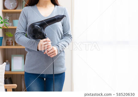 Woman with hairdryer Woman with hairdryer 58520630