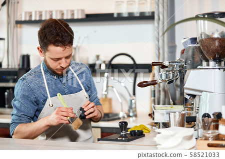 Young bearded man standing at bar counter 58521033