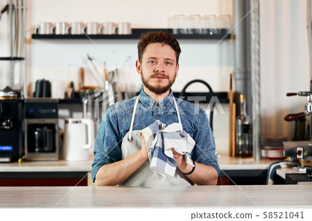 Handsome male barista working at counter Handsome male barista working at counter 58521041