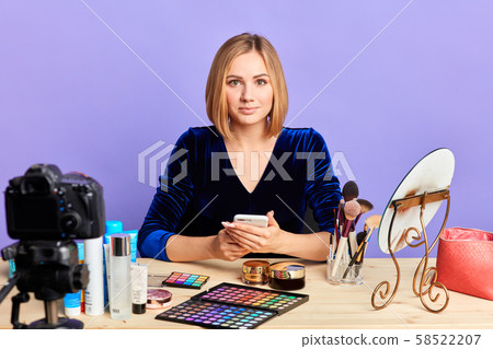 Charming young model preparing for shooting make up products advertisement Charming young model preparing for shooting make up products advertisement 58522207