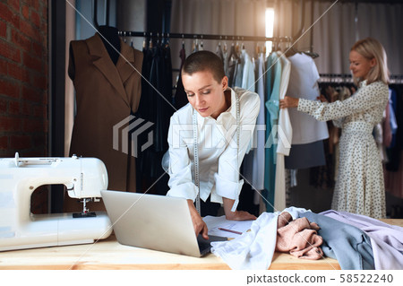 Attractive female tailor look at laptop Attractive female tailor look at laptop 58522240