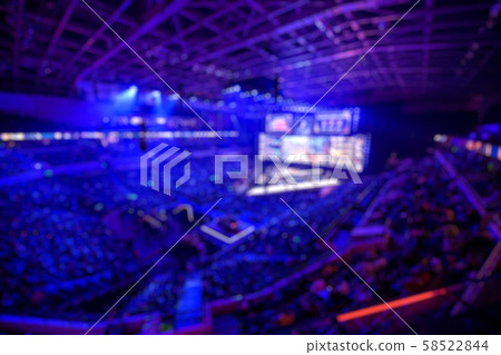 Blurred background of an esports event - The winner of tournament team on a stage with a cup award 58522844