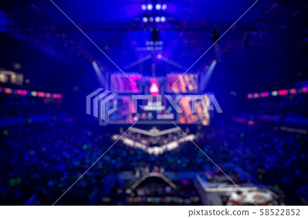 Blurred background of an esports event - big illuminated main stage of a computer games tournament 58522852
