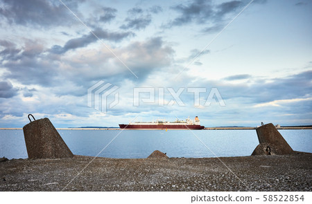 Concrete breakwater with a LNG tanker in distance Concrete breakwater with a LNG tanker in distance 58522854