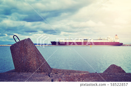 Concrete breakwater with a LNG tanker in distance Concrete breakwater with a LNG tanker in distance 58522857