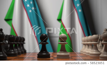 Chess game against flags of Uzbekistan. Political competition related 3D rendering 58523851