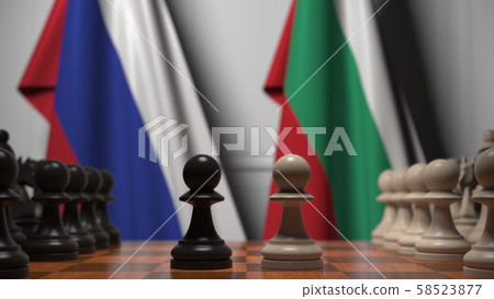 Flags of Russia and Bulgaria behind pawns on the chessboard. Chess game or political rivalry related Flags of Russia and Bulgaria behind pawns on the chessboard. Chess game or political rivalry related 58523877